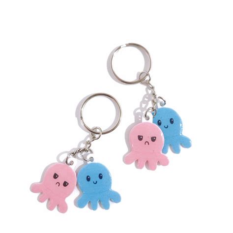 Two Octopus Key Chains With Blue And Pink Squids Hanging From It S Sides