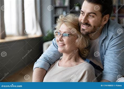 Hopeful Mature Mother And Adult Son Visualizing At Home Stock Image Image Of Optimistic Look