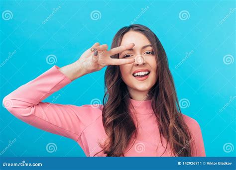 happy beautiful woman showing peace sign isolated on blue background stock image image of