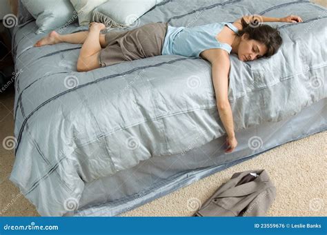 exhausted woman covering her ears with a duvet royalty free stock image