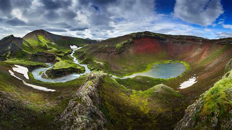 River Between Green And Red Covered Mountain Under White Cloud And Blue