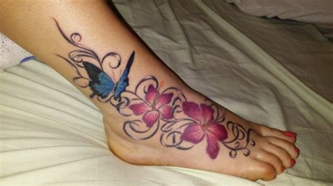 Beautiful Butterfly And Colorful Flowers Tattooed On The Womans Ankle