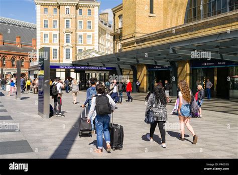 Exterior Of Kings Cross Railway Station With Commuters Walking Towards