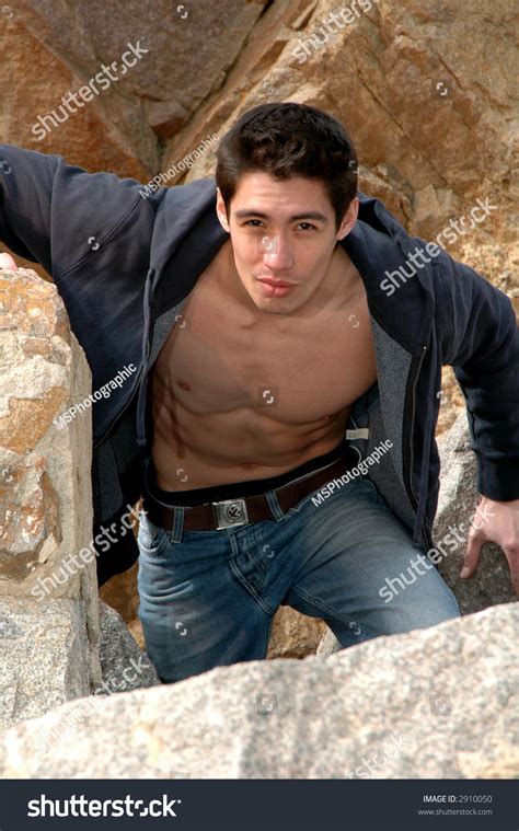 A Man Climbing A Rocky Mountain Stock Photo 2910050