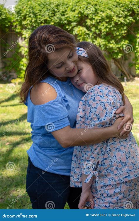 Latina Mother And Daughter Smiling And Laughing Outside In Back Yard Stock Image Image Of