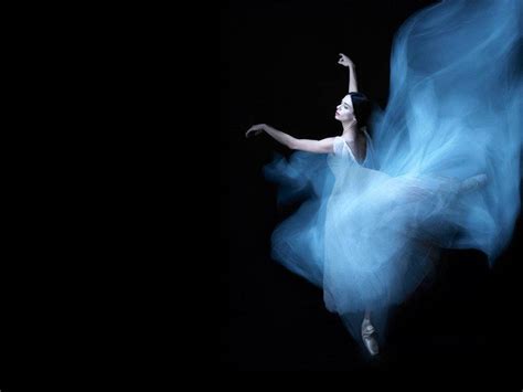 Download Ballet Dancer Floating In Blue Gown Wallpaper