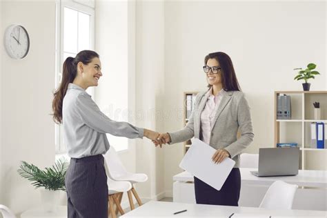 Happy Business Woman And Client Smiling And Shaking Hands Confirming