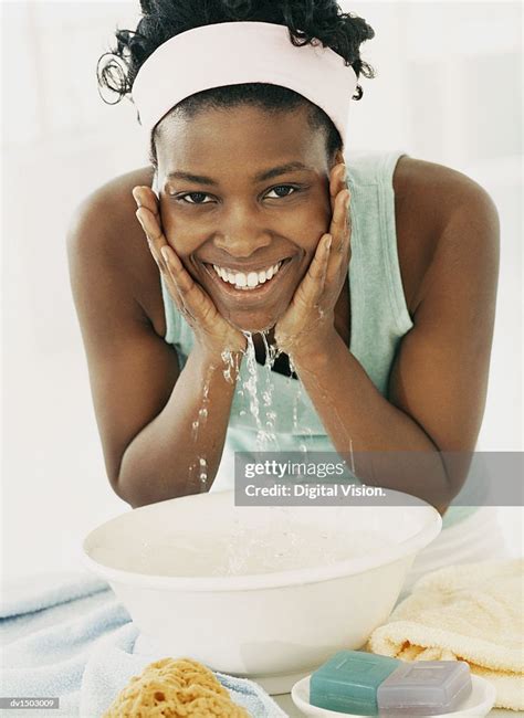 Woman Bending Over To Wash Her Face In A Bowl High Res Stock Photo