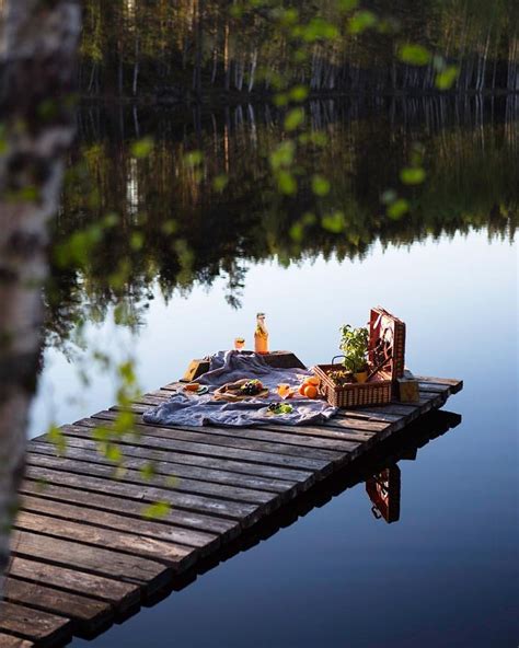 A Picnic Is Set Up On A Dock By The Water