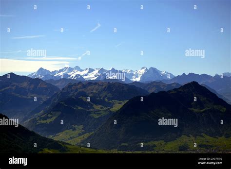 Panoramic Landscape View Of Meadows Mountain Ranges And Snowy Mountain