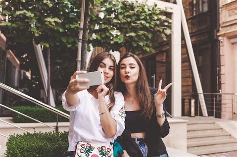 Premium Photo Two Funny Girls Take A Selfie Friends Take A Selfie On