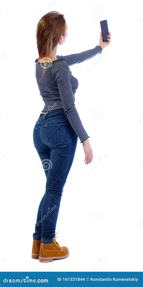 Back View Of A Woman Who Makes Selfie With A Smartphone Stock Photo