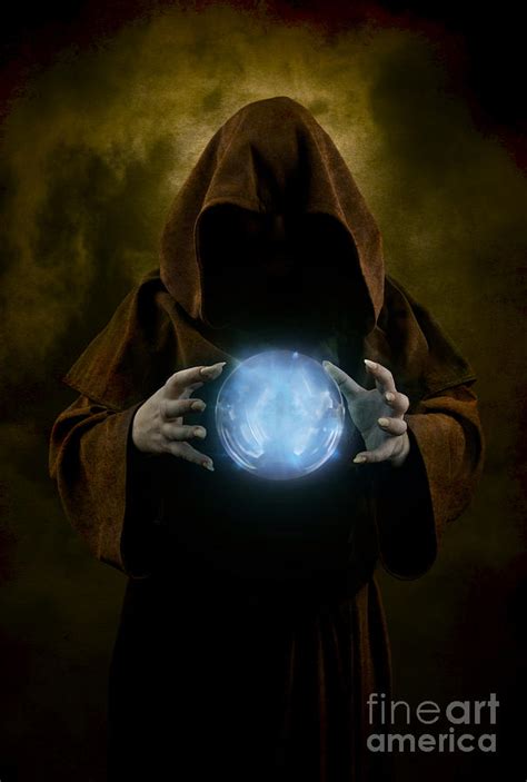 Mystery Man Wearing Cloak With Hood And Blue Glowing Crystal Ball