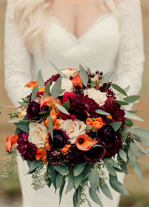 autumn wedding bouquet comprised of burgundy dahlias flame calla lilies sahara roses or