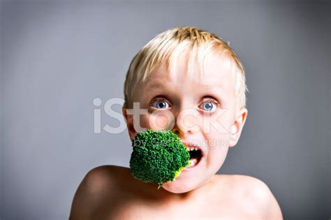 Boy With Broccoli Stuffed Into His Mouth Stock Photo Royalty Free