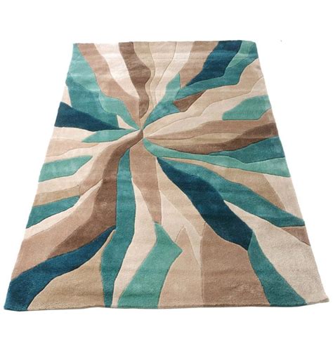 Because it embodies depth alongside warmth; Nebula Rug in Beige, Teal Blue and brown | Teal living ...