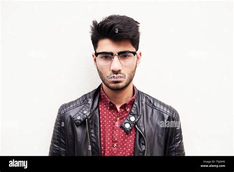 Portrait Of Handsome Bearded Guy In Stylish Glasses And Leather Jacket Over White Background