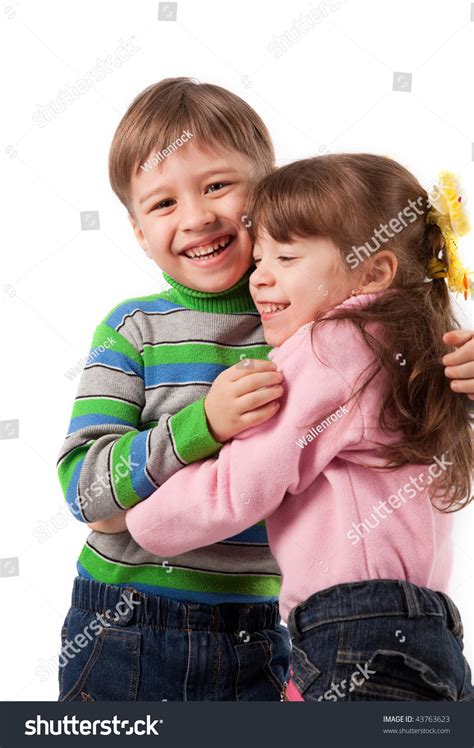 Happy Adorable Kids Hugging Each Other Stock Photo