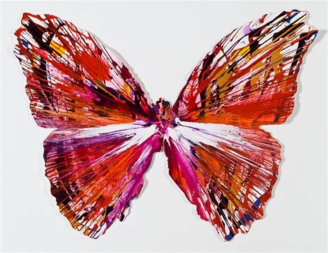 A Colorful Butterfly Made Out Of Paper On Top Of A White Surface With