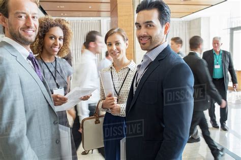 Group Of Business People Standing In Office Hall Smiling And Looking