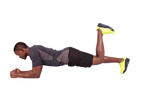 Fit Man Doing Front Plank With One Leg Raised