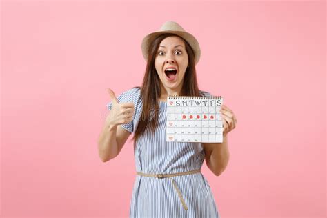 Portrait Of Excited Woman In Blue Dress Hat Holding Periods Calendar