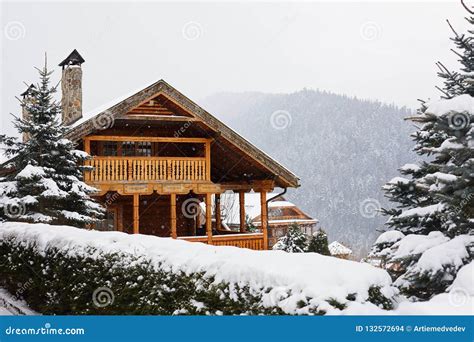 Christmas Wooden Mansion In Mountains On Snowfall Winter Day Cozy