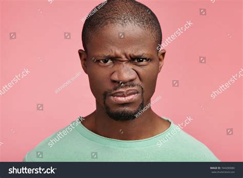 Displeased Discontent African American Male Frowns Stock Photo