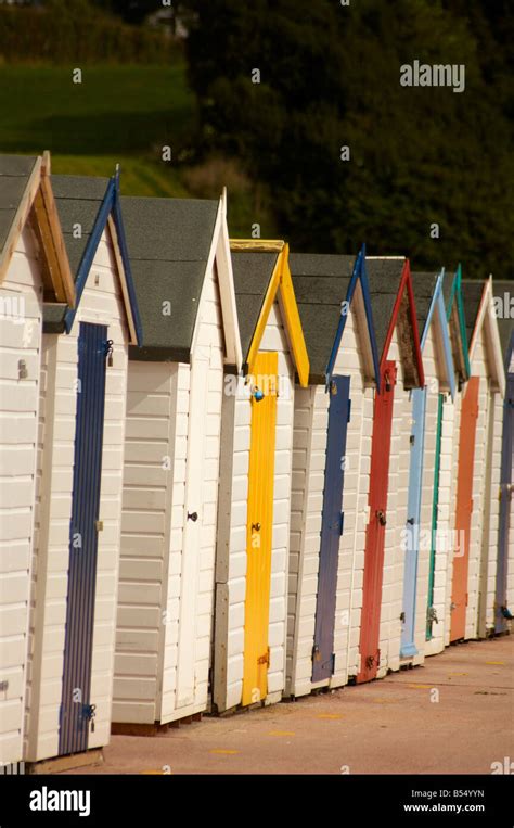 Row Of Brightly Coloured Beach Huts On The English Riviera Seafront At