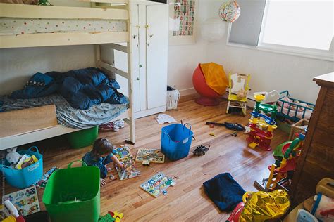 Toddler Playing In Messy Room Del Colaborador De Stocksy Rob And