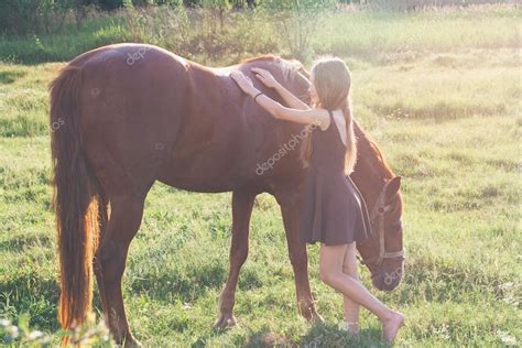 Girl Stroking Her Horse Stock Photo By ©yanapoles 105518730