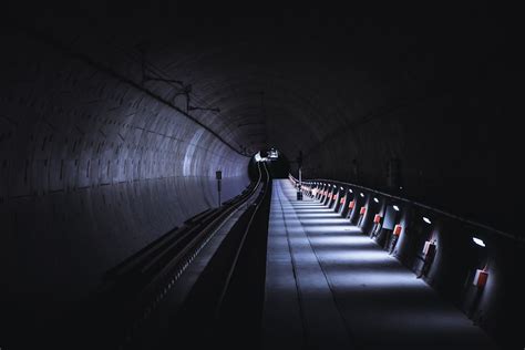 People Walking On Tunnel During Nighttime Photo Free Tunnel Image On