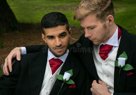 gay weddings grooms couples pose for pictures after their wedding ceremony in churchyard stock