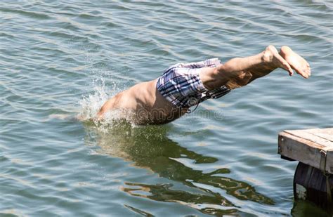 A Man Dives From Shore To Lake Stock Image Image Of Swimming River