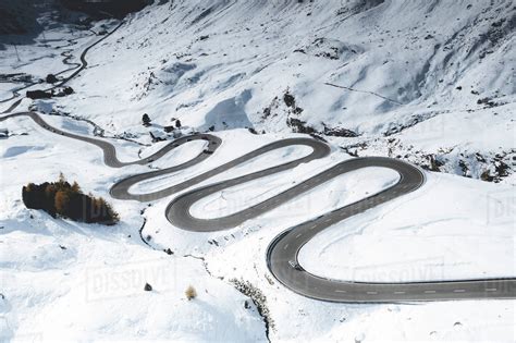 Car Traveling On Bends Of Winding Road In The Snow Julier Pass Albula