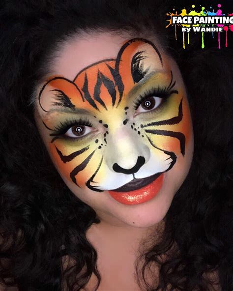 A Woman With Tiger Face Paint On Her Face