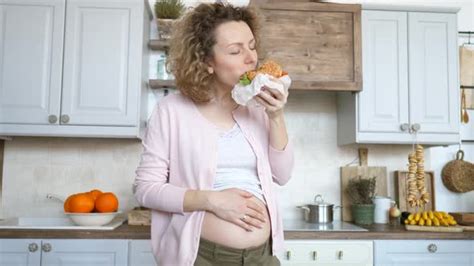 Young Pregnant Woman Eating Burger Unhealthy Food During Pregnancy