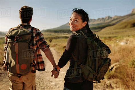 Young Woman With Her Boyfriend On Walk Through Countryside Happy Young