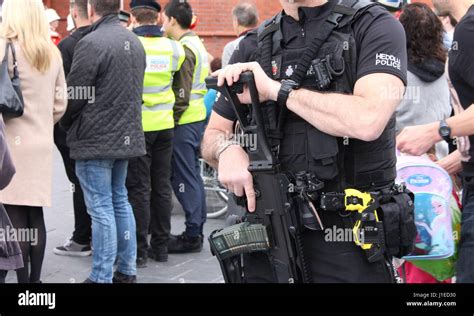 An Armed South Wales Police Officer Oversees The Crowd During A 21 Gun