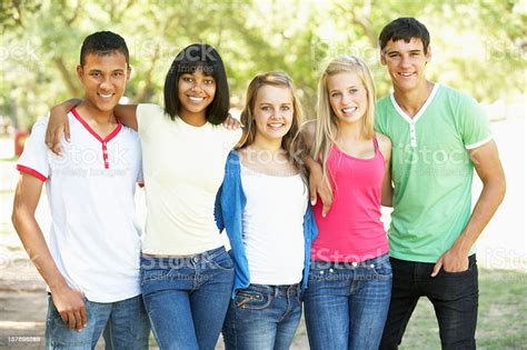 Group Of Teenage Friends Standing In Park Stock Photo - Download Image ...