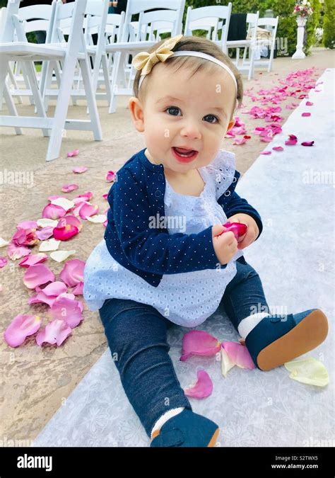 Baby Holding Flower Petals At Wedding Stock Photo Alamy
