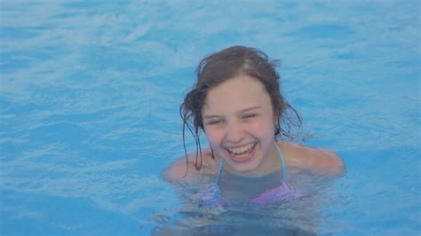 Young Girl Swims In Swimming Pool Teen Girl Enjoys Summer Vacation On