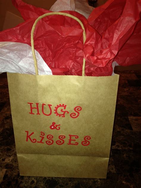 Brown Paper Bags Filled With Hershey Hugs And Kisses In Neat Mugs