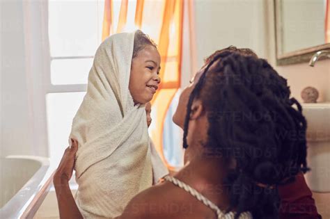 Happy Mother Drying Daughter Off With Towel After Bath Stock Photo