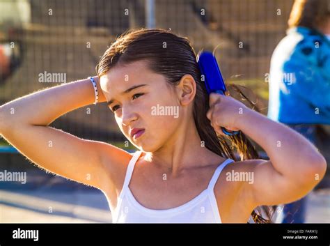 Junges Mädchen am Strand ihr nasses Haar bürsten nach dem Schwimmen