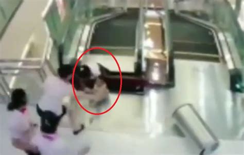 Chinese Woman Getting Crushed To Death By An Escalator But Saves Son