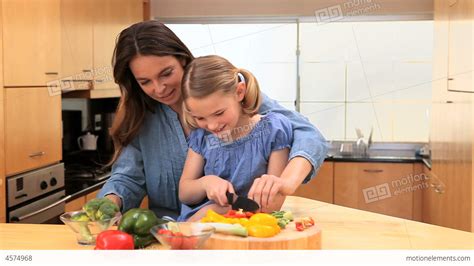 Smiling Mother Cooking With Her Daughter Stock Video Footage 4574968