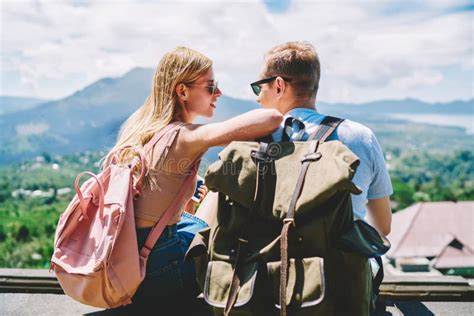 Happy Couple With Backpacks Looking At Each Other Stock Photo Image