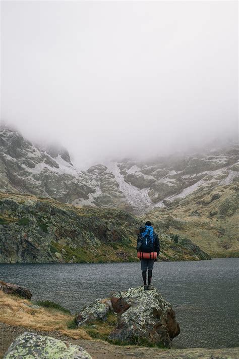 Backpacker Contemplating A Lake In The Mountains Del Colaborador De Stocksy Miquel Llonch