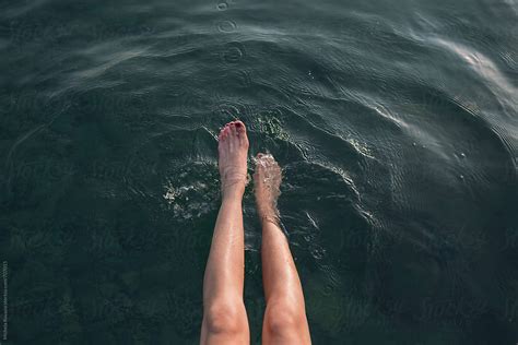 Female Legs Dangling In The Water By Stocksy Contributor Michela